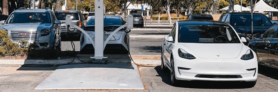 A row of EV chargers with a Tesla at one.
