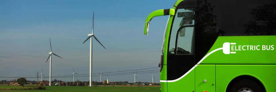 Electric bus operations in the countryside with windmill in background