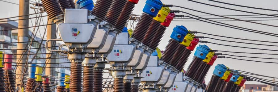 Row of grid transformers and power lines.